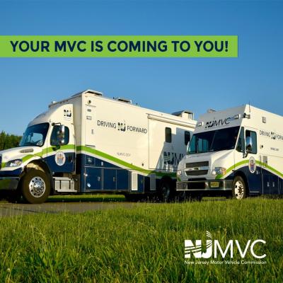 Two large trucks parked on grass with NJMVC marekings